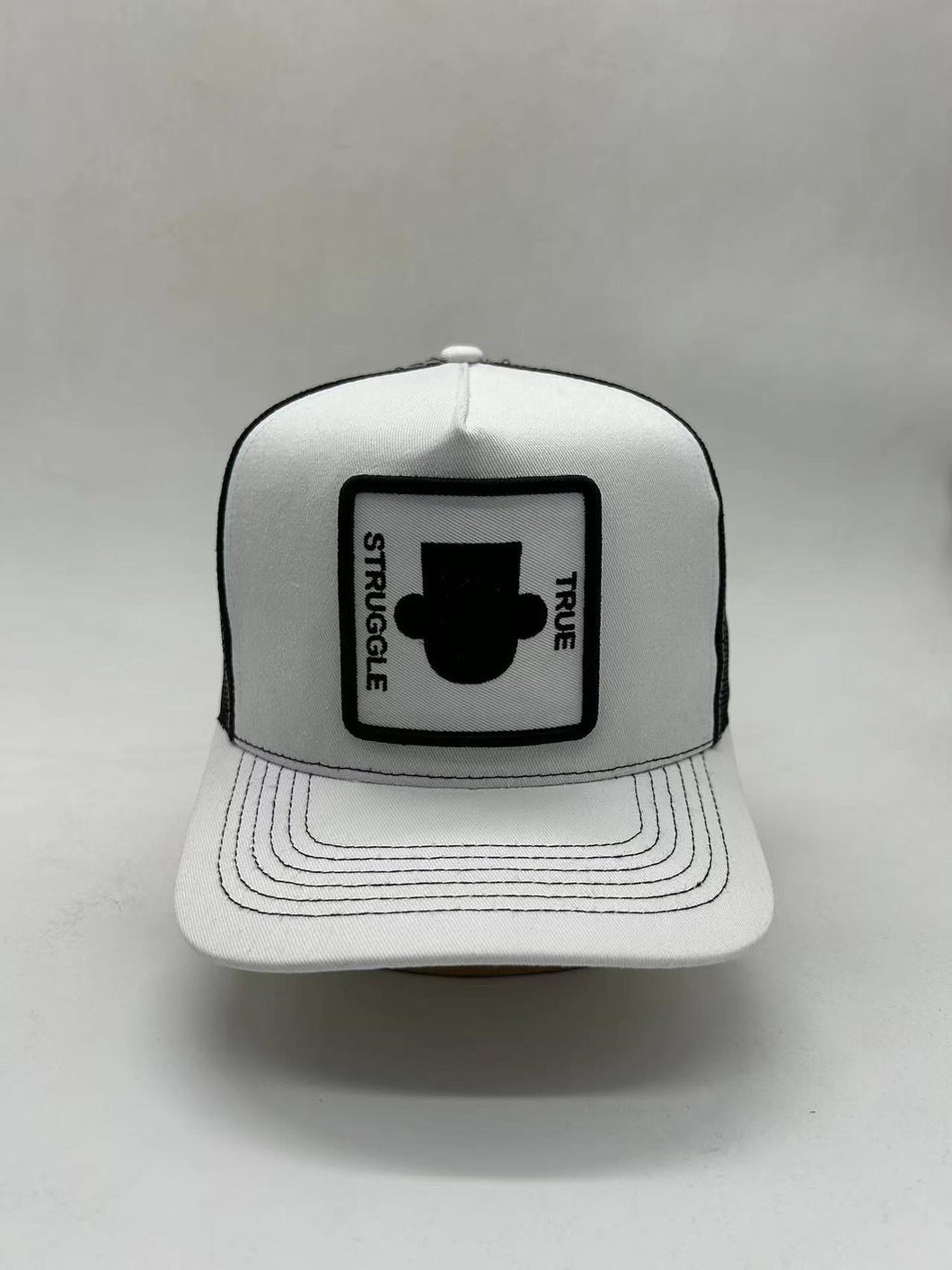 White/Black snapback cap/Mesh Black back with Black silhouette logo character face only embroidered on front center